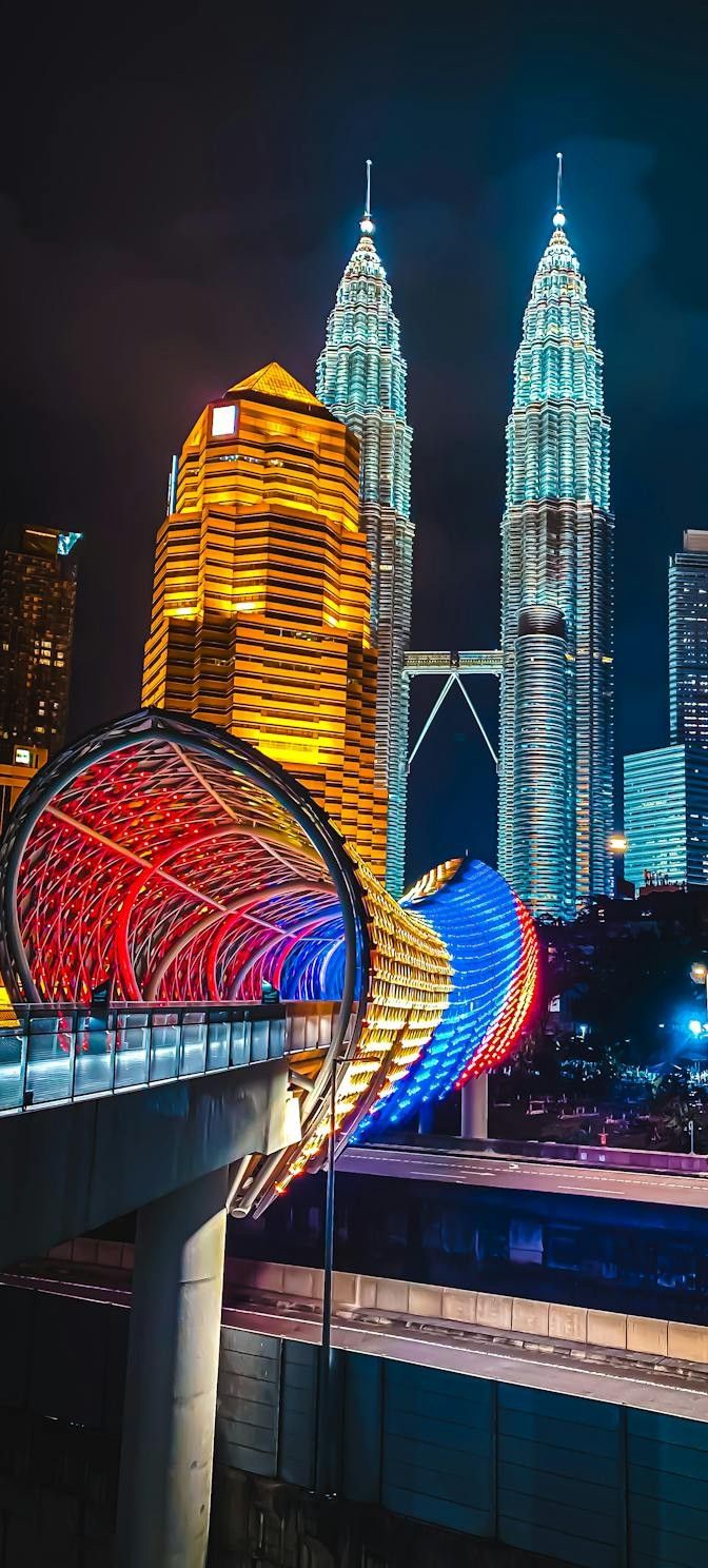 Petronas Twin Towers and the illuminated Saloma Link bridge at night in Kuala Lumpur